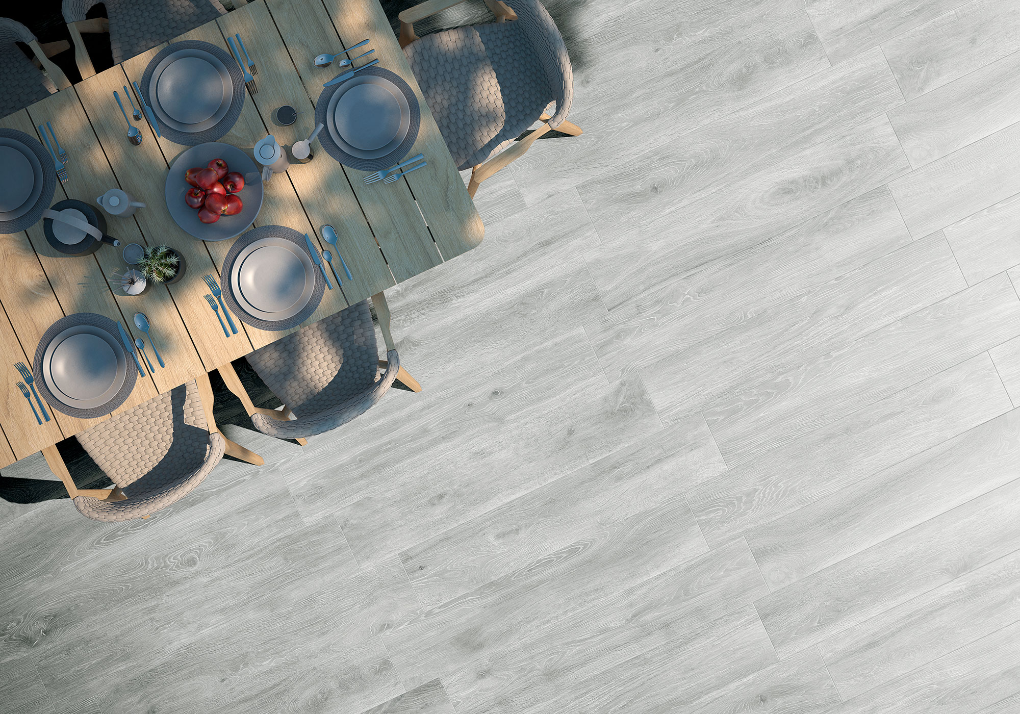 Suelo cerámico efecto madera gris claro junto a mesa puesta y sillas