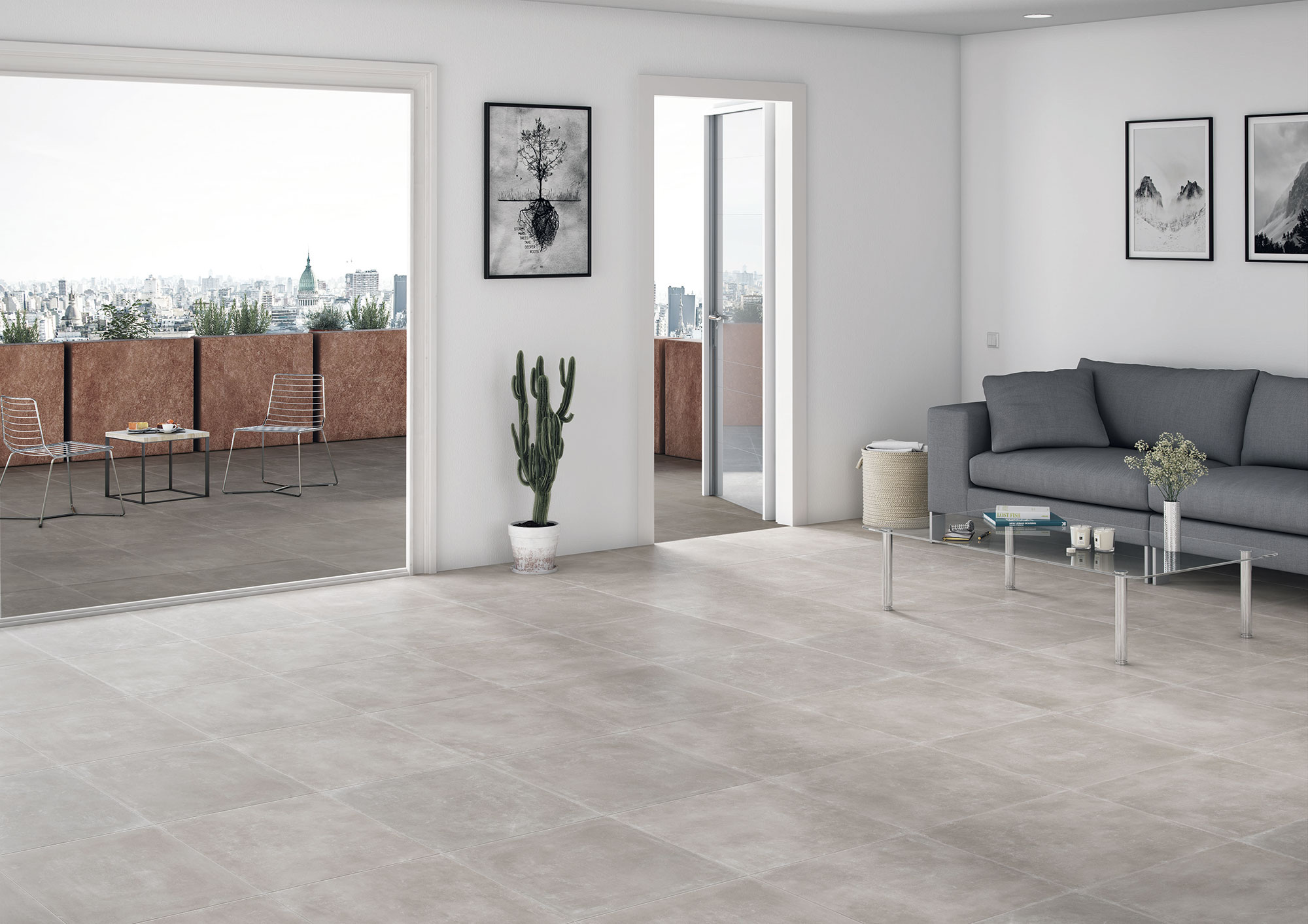 Salón minimalista con azulejos de gran formato efecto cemento, sofá y terraza