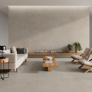 AMB_STN_KRETA-GREIGE-60X120_100X100 Salón minimalista con grandes azulejos beige en suelo y pared, chimenea lineal y mobiliario madera.