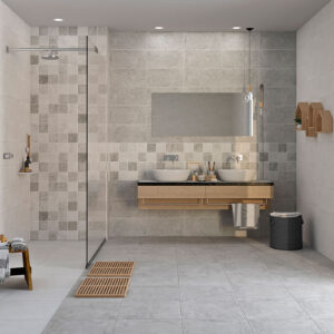 Baño exposición con pavimento y revestimiento cerámico gris, ducha a la italiana y doble lavabo