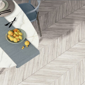 Comedor con mesa redonda y pavimento cerámico efecto madera en patrón espiga